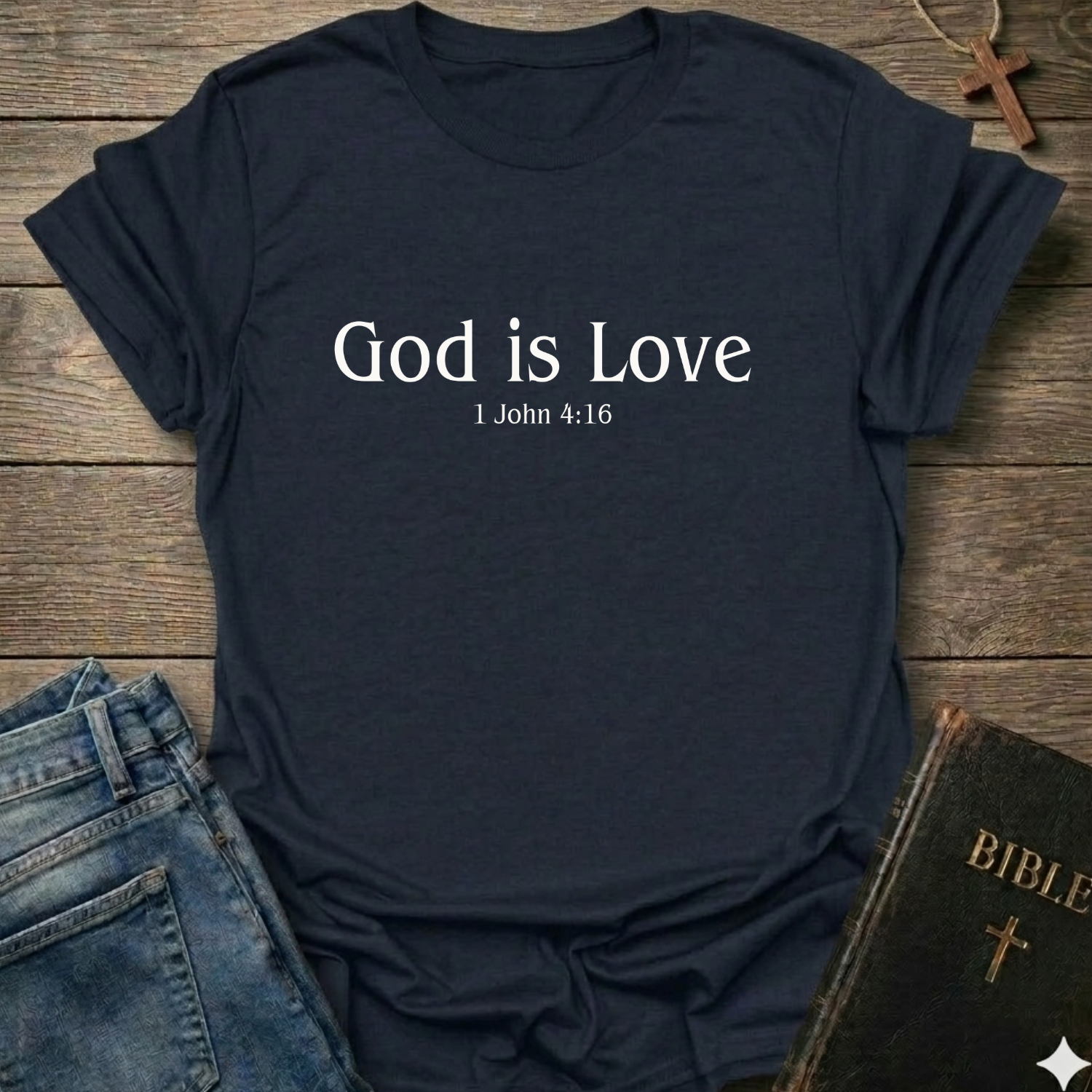 Navy blue with 'God is Love'  Christian T-Shirt 1 John 4:15 elegant faith apparel Faith Forward text. T-shirt on a wooden surface with jeans and a Bible.