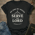 Black t-shirt with Me and My House Serve the Lord | Joshua 24:15 Faith Forward text on a wooden surface with jeans and a Bible.