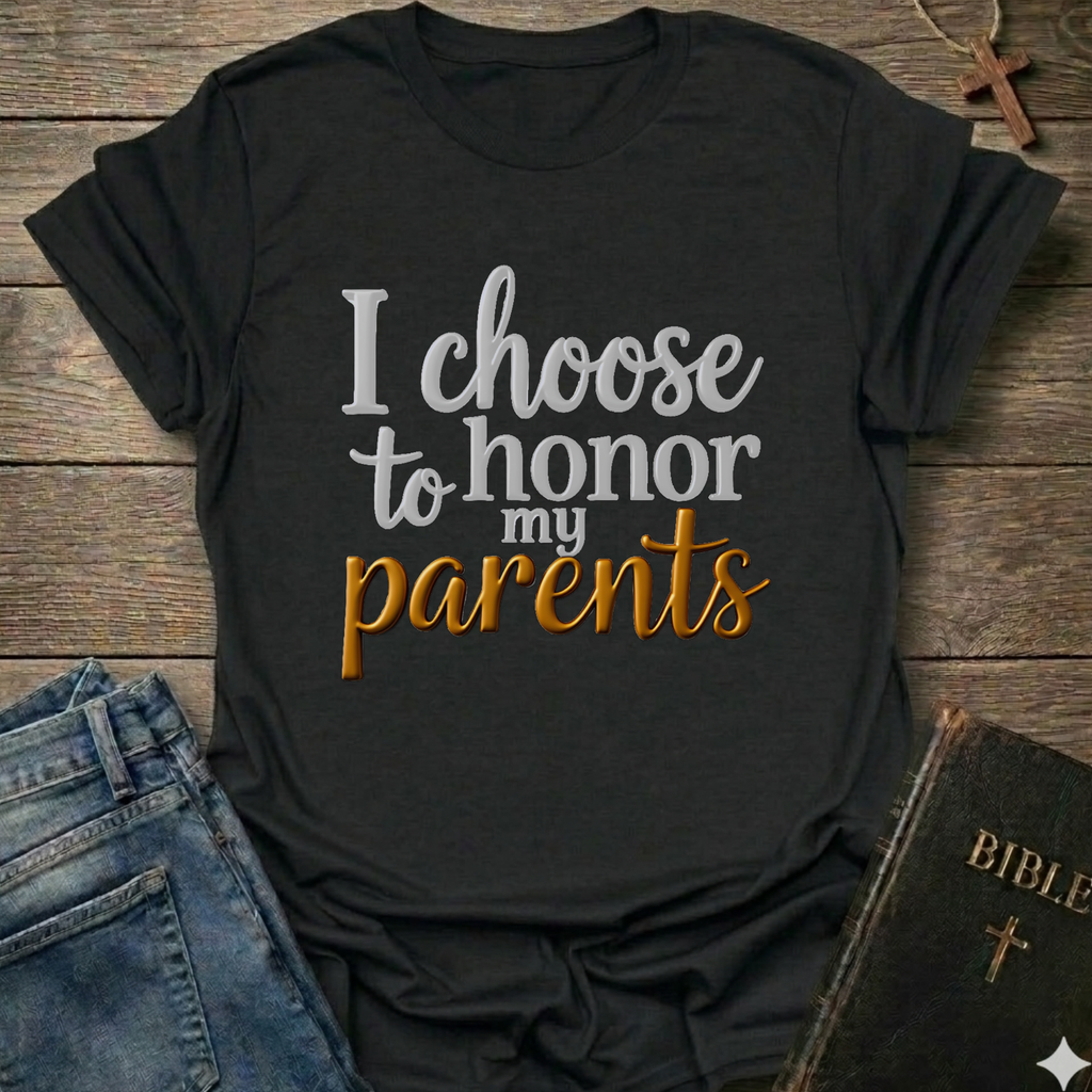 Black t-shirt with 'I choose to honor my parents' Exodus 20:12 text navy gold Christian faith apparel conversation starter. T-shirt is on a wooden surface with jeans and a Bible.