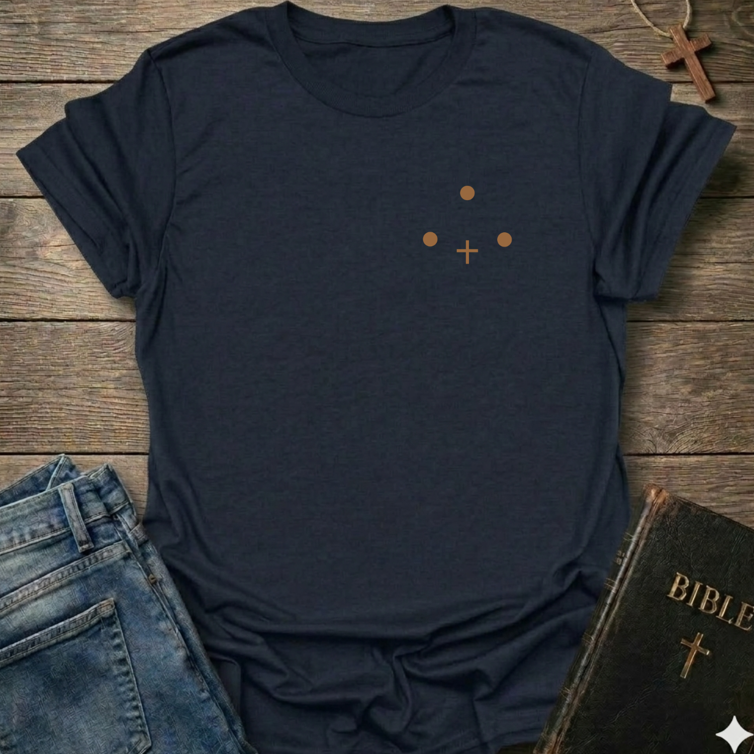 Black t-shirt with Three Dots and a Cross Minimal Christian T-Shirt conversation starter faith apparel on a wooden surface with jeans and a Bible.