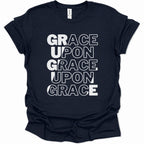 A navy blue short-sleeve t-shirt with a white graphic text print reading 'GRACE UPON GRACE UPON GRACE' stacked vertically on the front, shown against a plain white background.