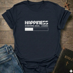 A navy blue graphic t-shirt  laid flat on a rustic wooden surface, styled with blue jeans and a Bible. The t-shirt features a white printed loading bar "like a battery charging" graphic that reads 'HAPPINESS IS KNOWING JESUS.