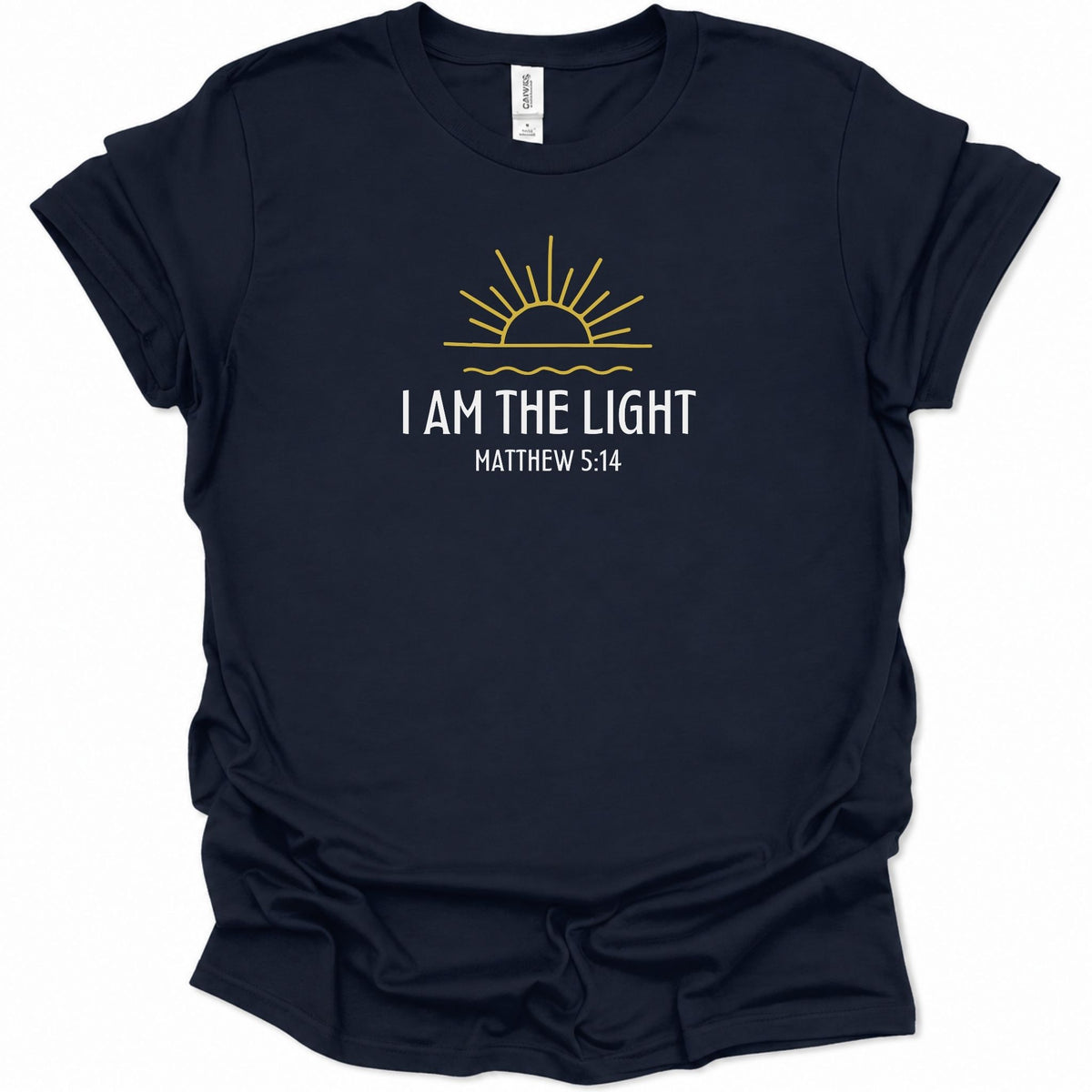 A navy blue short-sleeve t-shirt with a graphic on the chest featuring a yellow sun and the text 'I AM THE LIGHT MATTHEW 5:14' in white, displayed on a clean white background.