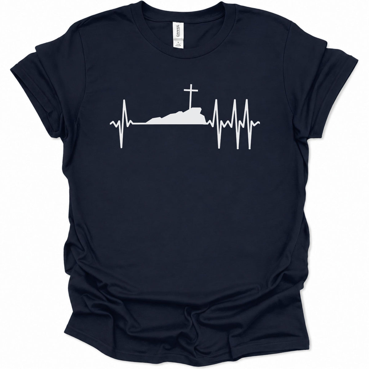 A navy blue short-sleeve t-shirt with a white graphic print of a heartbeat EKG line forming a silhouette of a hill with a cross on top, displayed on a clean white background.