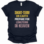 A navy blue short-sleeve t-shirt with a distressed typographic graphic on the front reading 'SHORT-TERM ON EARTH PREPARE FOR LONGTERM IN HEAVEN' in yellow, white, and pink lettering, shown on a plain white background.