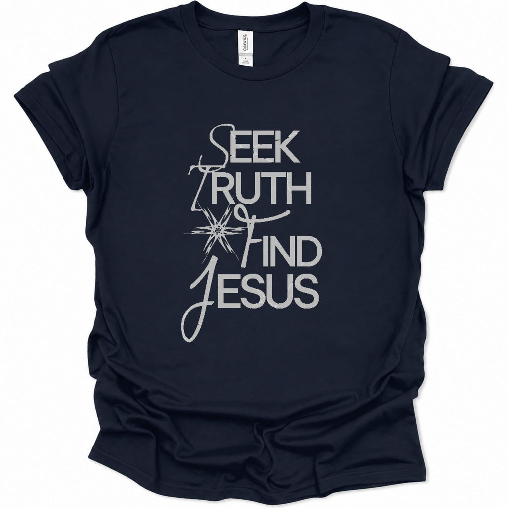 A navy blue short-sleeve t-shirt with a white graphic print on the front reading 'SEEK TRUTH AND JESUS' in a stylized font, displayed against a plain white background.