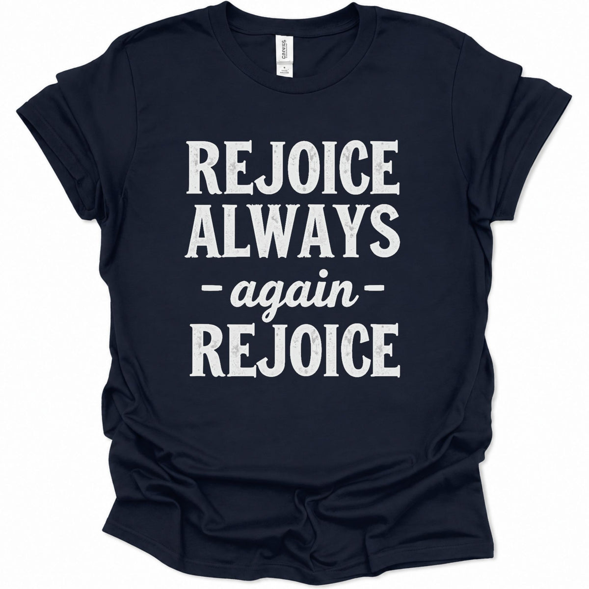 A navy blue short-sleeve t-shirt with the phrase 'REJOICE ALWAYS - again - REJOICE' printed in distressed white block letters on the front, displayed against a plain white background.