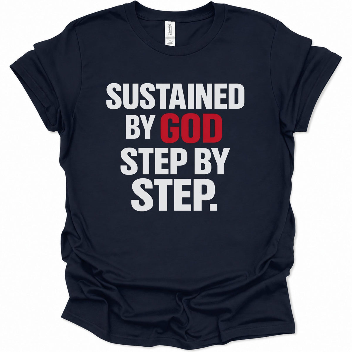 A navy blue short-sleeve t-shirt with a bold text graphic reading 'SUSTAINED BY GOD STEP BY STEP.' in white and red lettering, displayed on a clean white background.