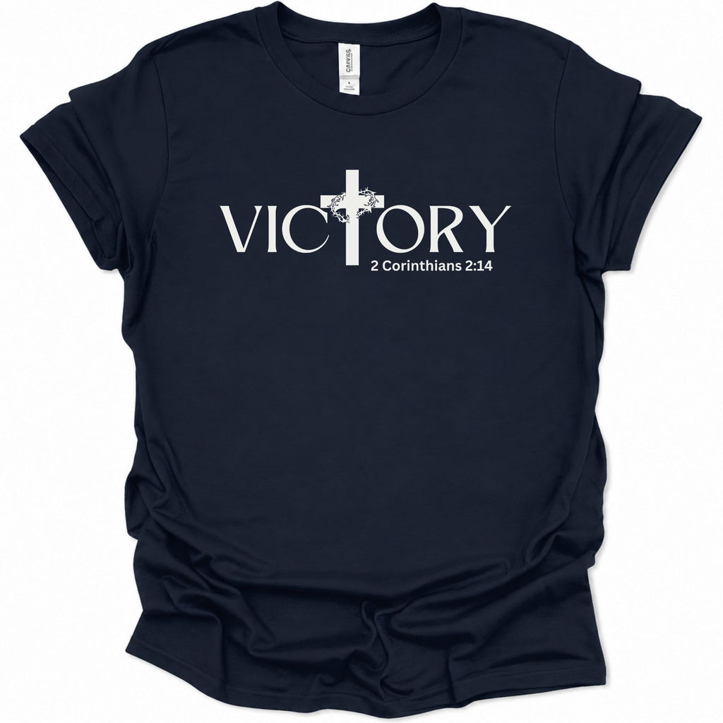 A navy blue short-sleeve t-shirt with the text 'Be Christlike The world will adjust' printed in white across the chest, accompanied by a small yellow smiley face graphic.