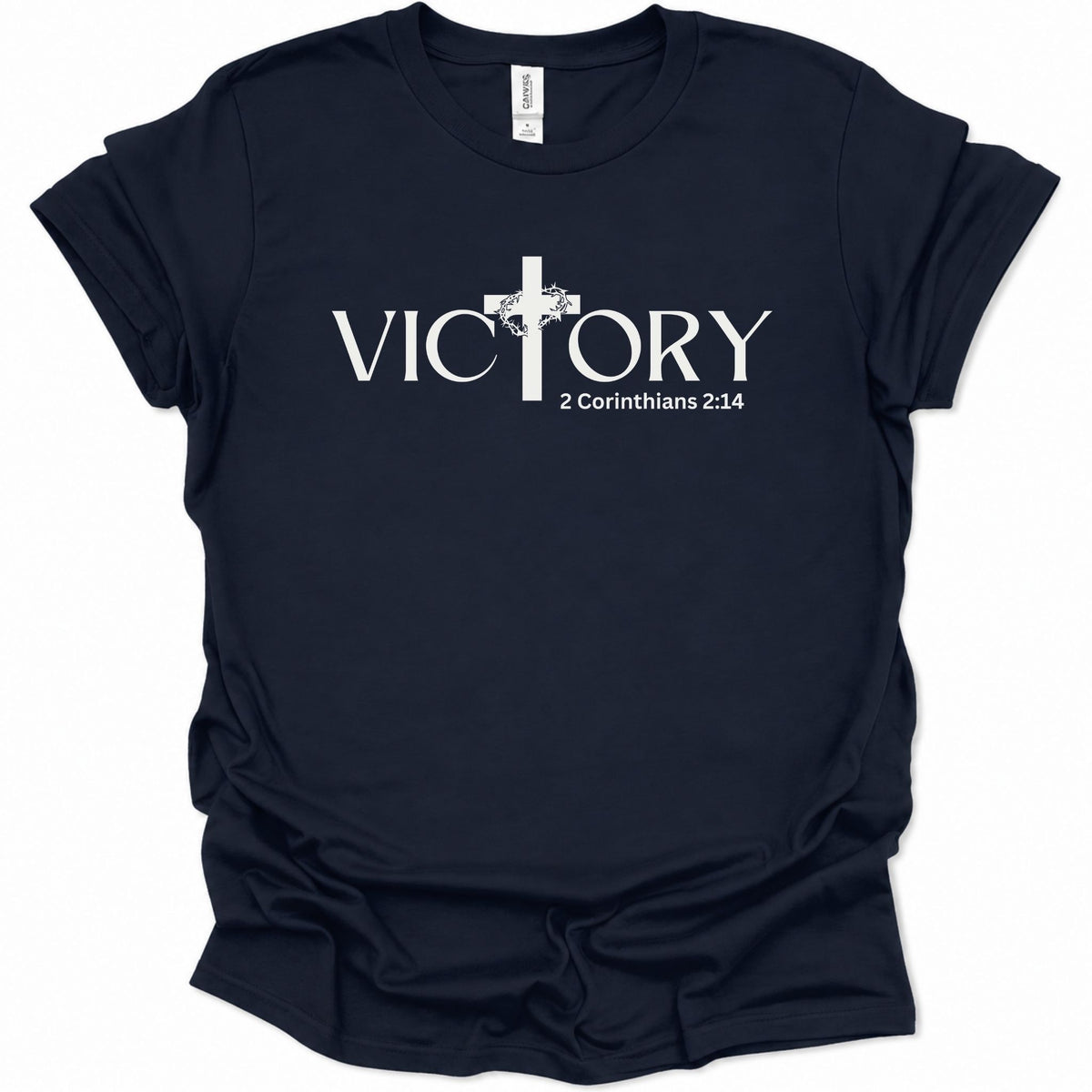 A navy blue short-sleeve t-shirt with the text 'Be Christlike The world will adjust' printed in white across the chest, accompanied by a small yellow smiley face graphic.