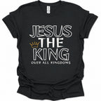 A black short-sleeve t-shirt with a graphic print reading 'JESUS THE KING OVER ALL KINGDOMS' in white outlined lettering, featuring a small gold crown icon between 'THE' and 'KING'.