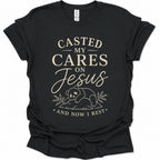 A black short-sleeve graphic t-shirt with a cream-colored text print reading 'CASTED MY CARES ON Jesus AND NOW I REST' and a small bear illustration, shown on a plain white background.