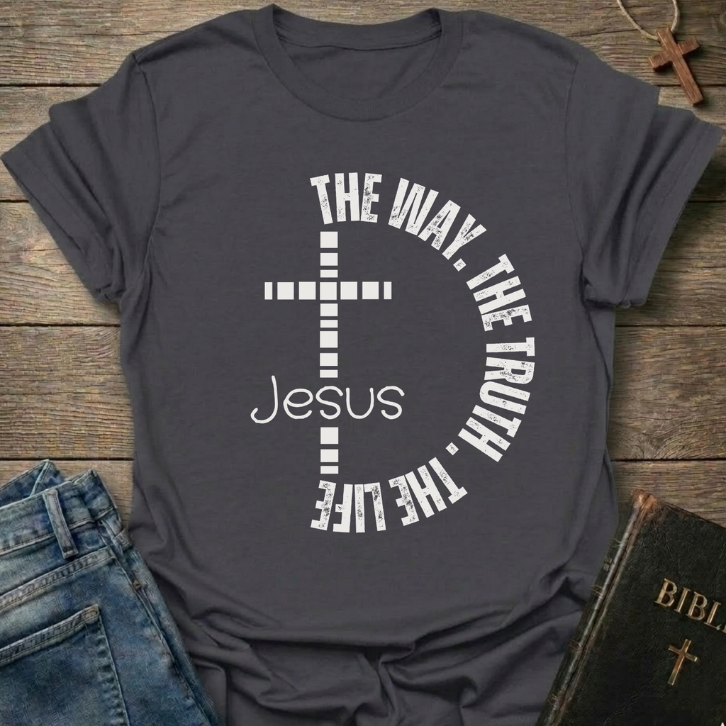 Gray t-shirt with a cross and text  "Jesus The Way The Truth The Life Cross Circle John 14:6" Christian faith apparel Faith Forward. It is on a wooden surface with jeans and a Bible.