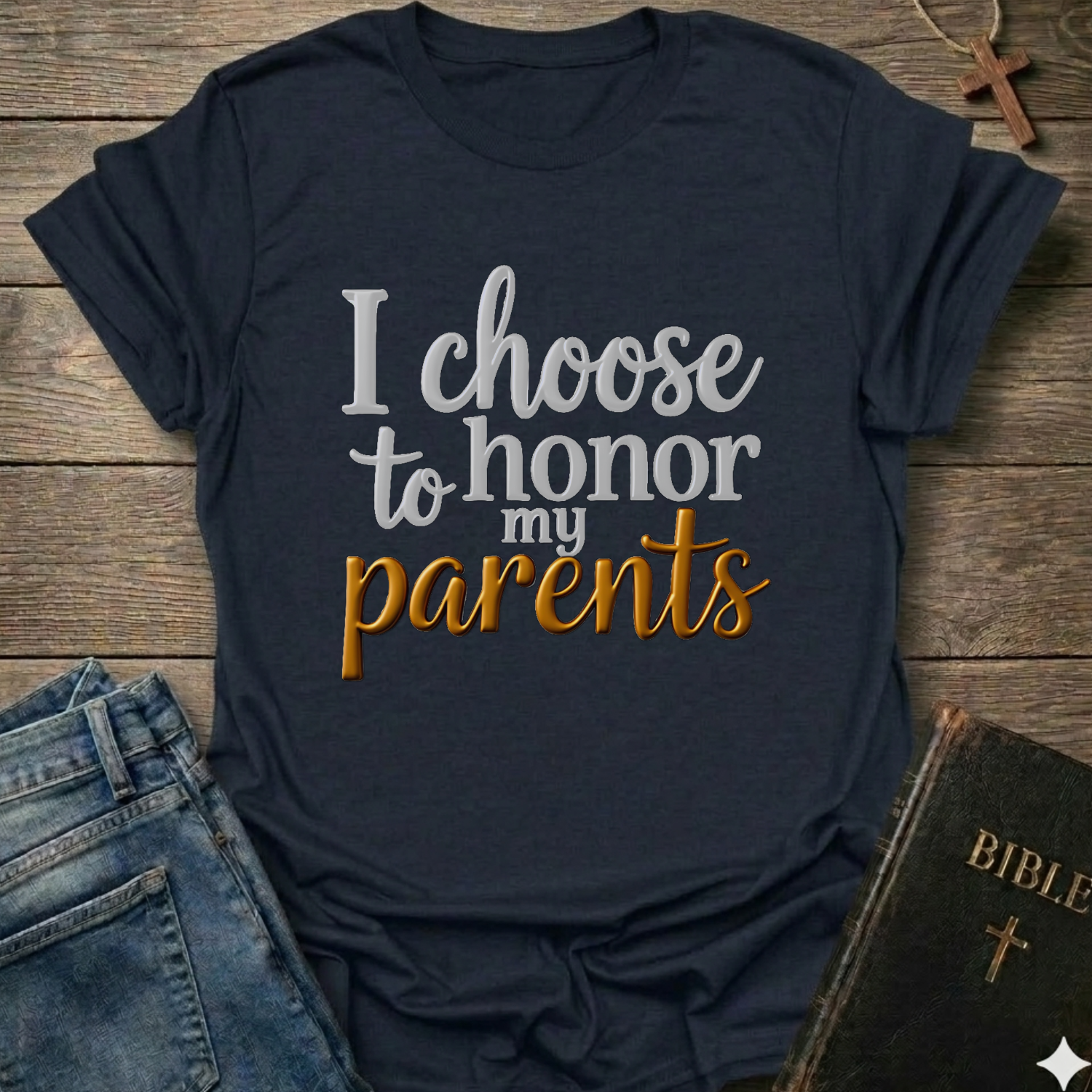 Navy blue t-shirt with 'I choose to honor my parents' Exodus 20:12 text navy gold Christian faith apparel conversation starter. T-shirt is on a wooden surface with jeans and a Bible.