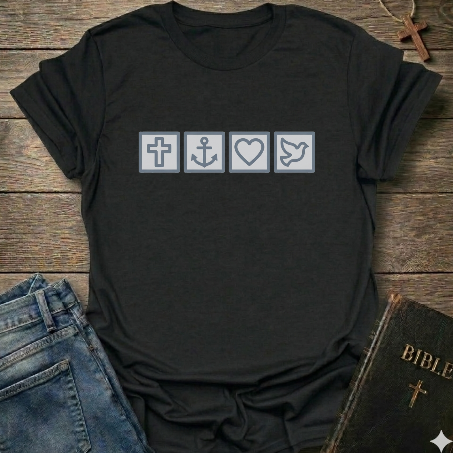 Black t-shirt with Biblical Relatable Symbols Christian T-Shirt faith apparel conversation starter on a wooden surface with jeans and a Bible.