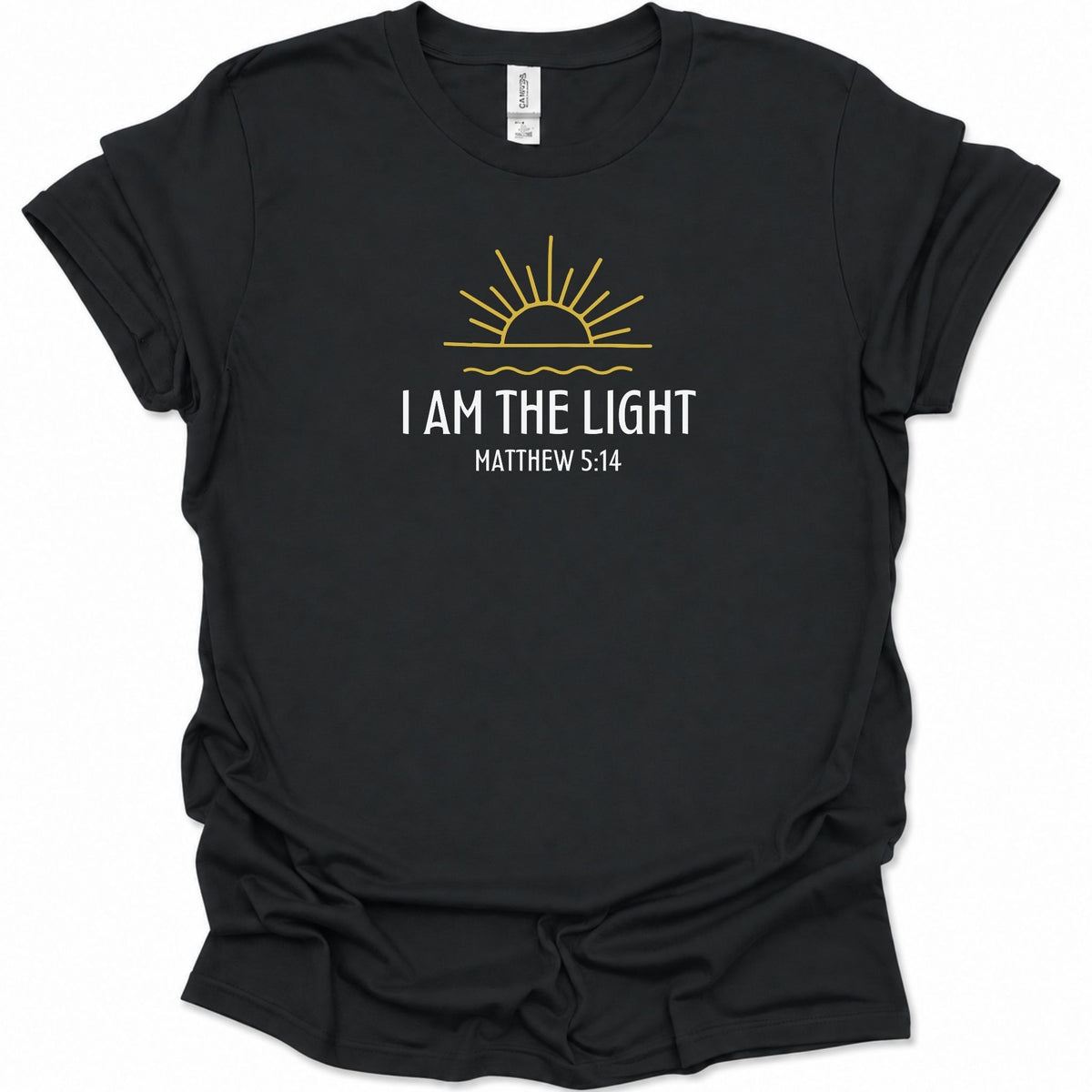 A black short-sleeve t-shirt with a graphic print on the front featuring a yellow rising sun and the text 'I AM THE LIGHT MATTHEW 5:14' in white, displayed on a clean white background.