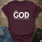 Maroon t-shirt with 'With GOD all things are possible' Matthew 19:26 bold faith apparel conversation starter
text on a wooden surface with jeans and a Bible.