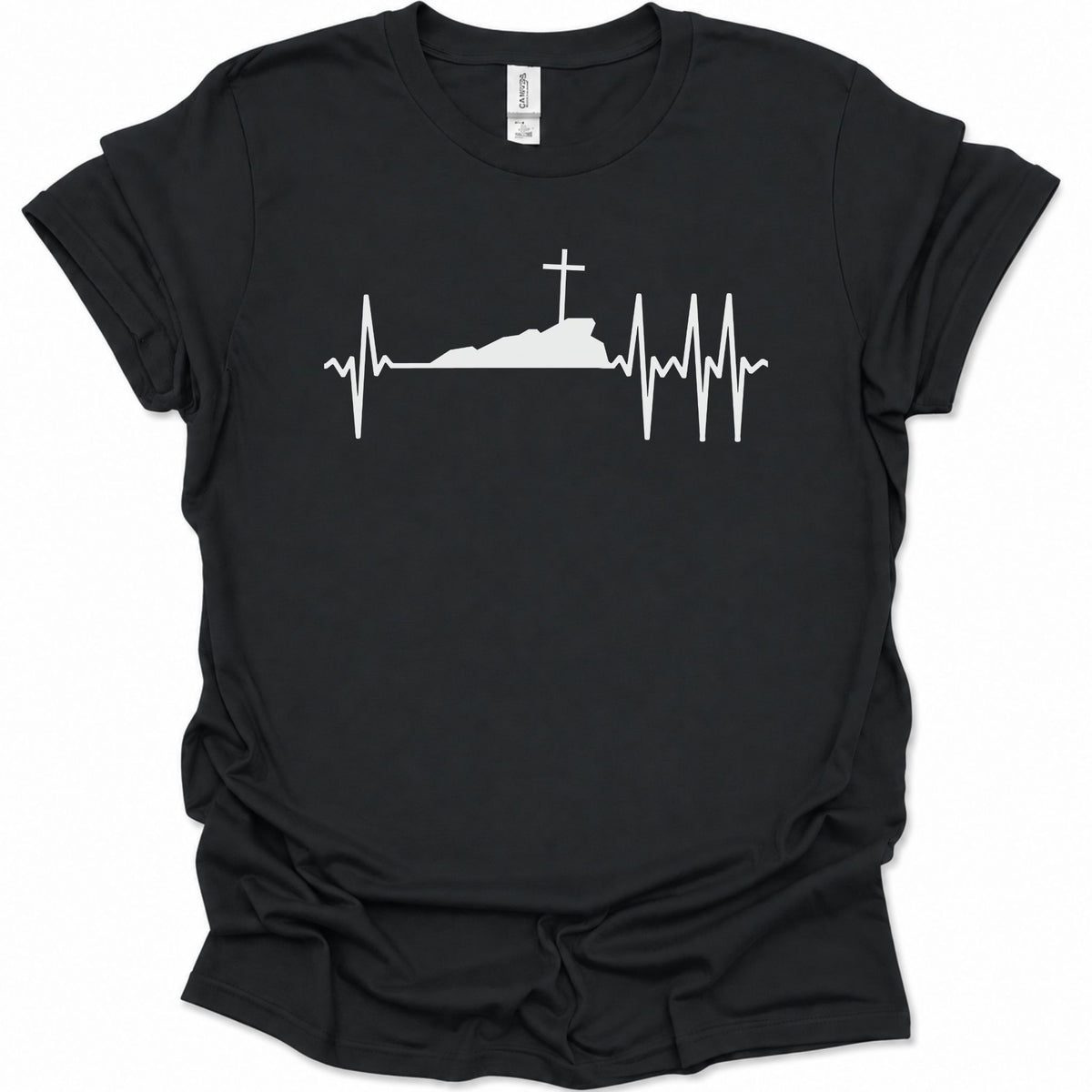 A black short-sleeve crewneck t-shirt with a white graphic print of a cross on top of a silhouette, integrated into an EKG heartbeat line, shown against a plain white background.