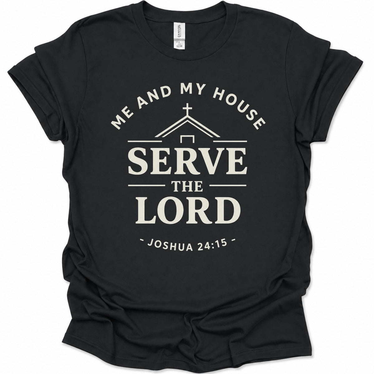 A black short-sleeve crewneck t-shirt with a cream-colored graphic print on the front. The graphic features a church silhouette, a cross, and the text 'ME AND MY HOUSE SERVE THE LORD - JOSHUA 24:15 -'.