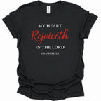 A black short-sleeve t-shirt with a printed Bible verse on the front reading 'MY HEART Rejoiceth IN THE LORD 1 SAMUEL 2:1' in white and red lettering, shown on a plain white background.