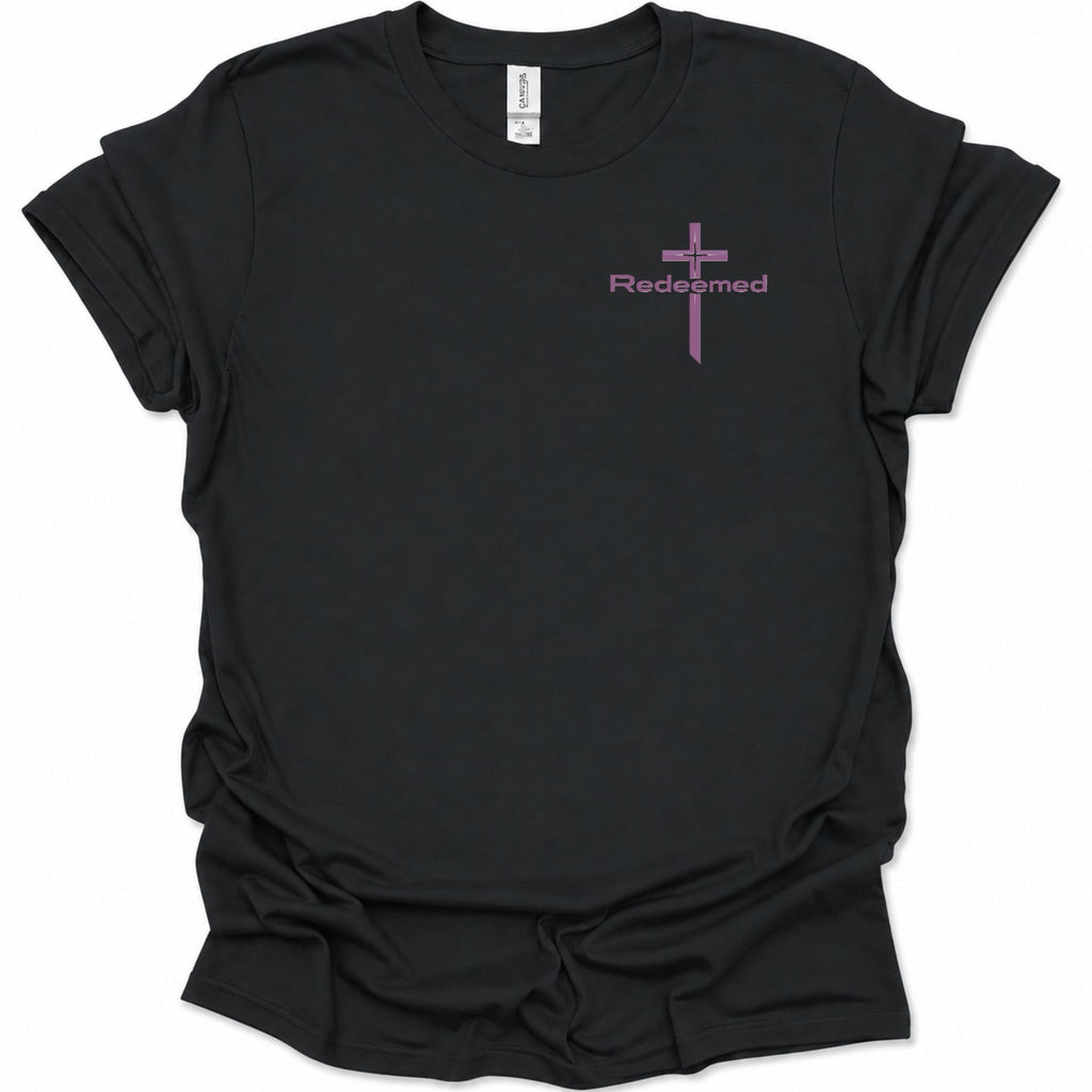 A black short-sleeve t-shirt with a small purple cross graphic and the word 'Redeemed' printed on the left chest, displayed on a clean white background.