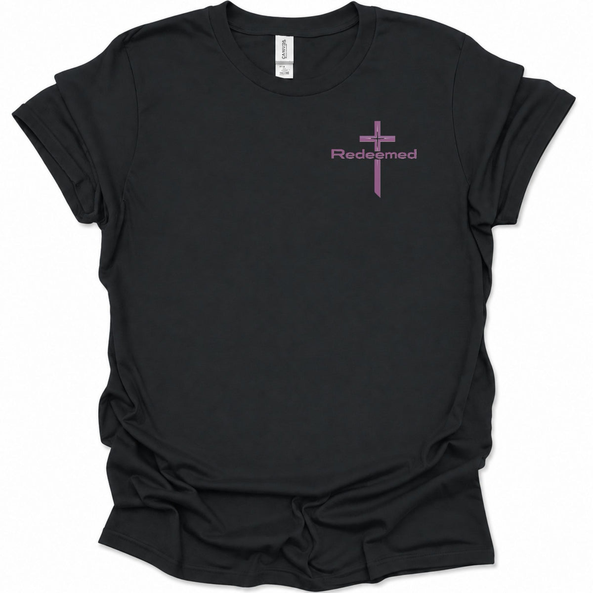 A black short-sleeve t-shirt with a small purple cross graphic and the word 'Redeemed' printed on the left chest, displayed on a clean white background.