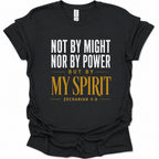 A black short-sleeve t-shirt with a printed biblical quote on the front reading 'NOT BY MIGHT NOR BY POWER BUT BY MY SPIRIT ZECHARIAH 4:6' in white and gold lettering, shown on a plain white background.