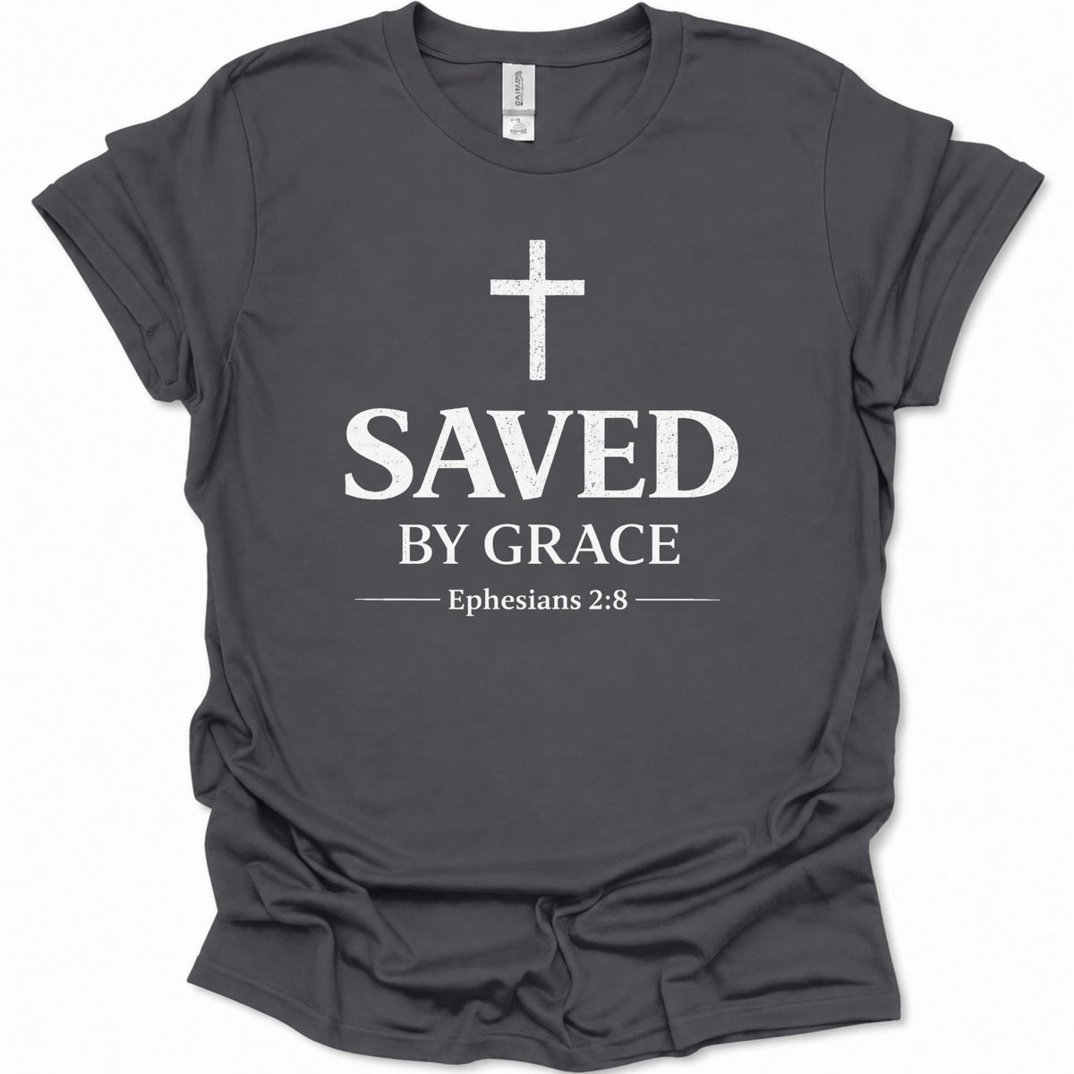 A dark heather gray short-sleeve t-shirt with a distressed white graphic print on the front featuring a cross, the words 'SAVED BY GRACE', and 'Ephesians 2:8'.