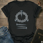 Black Christian T-Shirt Gospel faith apparel conversation starter with a crown of thorns and nails design on a wooden surface. 
