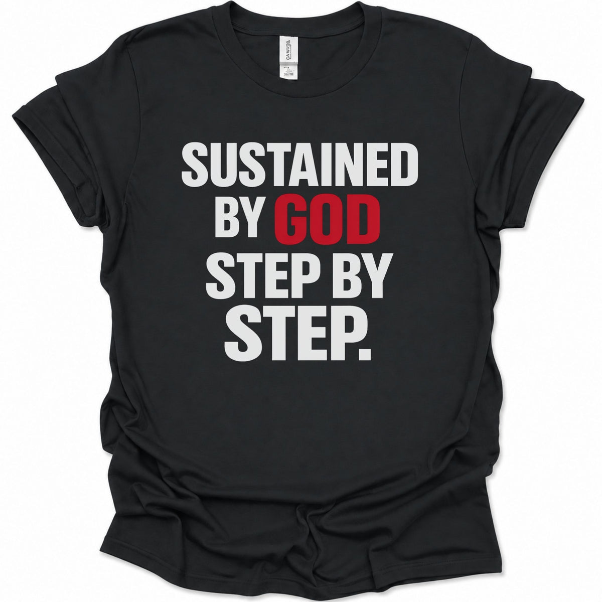 A black short-sleeve crewneck t-shirt with the text 'SUSTAINED BY GOD STEP BY STEP.' printed on the front in bold white and red letters, shown against a plain white background.