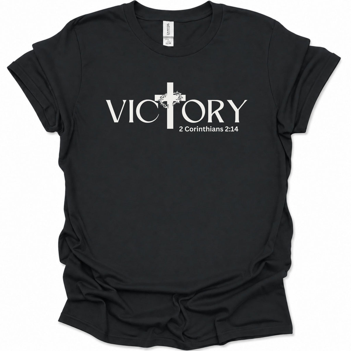 A black short-sleeve crewneck t-shirt with a white graphic print on the front. The graphic features the word 'VICTORY' in a serif font, with a Christian cross replacing the letter 'I'.