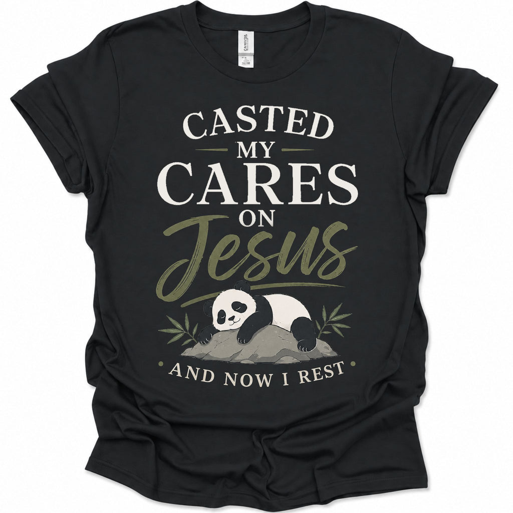 A black short-sleeve graphic t-shirt featuring a panda illustration and the text 'CASTED MY CARES ON Jesus AND NOW I REST' in white and olive green lettering, accompanied by an illustration of a sleeping panda resting on a rock with bamboo leaves.