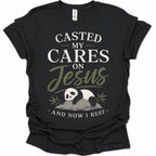 A black short-sleeve graphic t-shirt featuring a panda illustration and the text 'CASTED MY CARES ON Jesus AND NOW I REST' in white and olive green lettering, accompanied by an illustration of a sleeping panda resting on a rock with bamboo leaves.