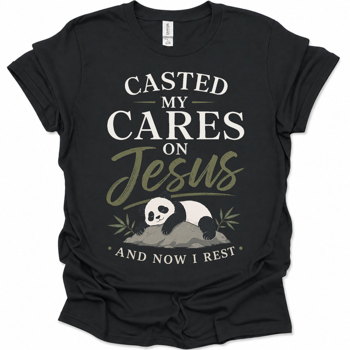 A black short-sleeve graphic t-shirt featuring a panda illustration and the text 'CASTED MY CARES ON Jesus AND NOW I REST' in white and olive green lettering, accompanied by an illustration of a sleeping panda resting on a rock with bamboo leaves.