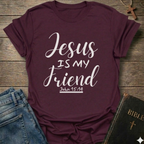 Maroon t-shirt with 'Jesus is my friend' text on a wooden surface with jeans and a Bible. Jesus is My Friend Christian T-Shirt John 15:14 bold faith apparel Faith Forward