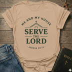Natural t-shirt with Me and My House Serve the Lord | Joshua 24:15 Faith Forward text on a wooden surface with jeans and a Bible.