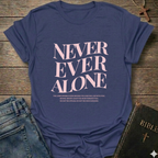 Purple t-shirt with 'NEVER EVER ALONE' text on a wooden surface with jeans and a Bible. Never Ever Alone Never Forsaken Christian T-Shirt Deuteronomy 31:8 bold faith apparel Faith Forward